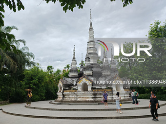 Tourists are enjoying the scenery in the Manting Imperial Garden in Xishuangbanna, China, on July 3, 2024. (