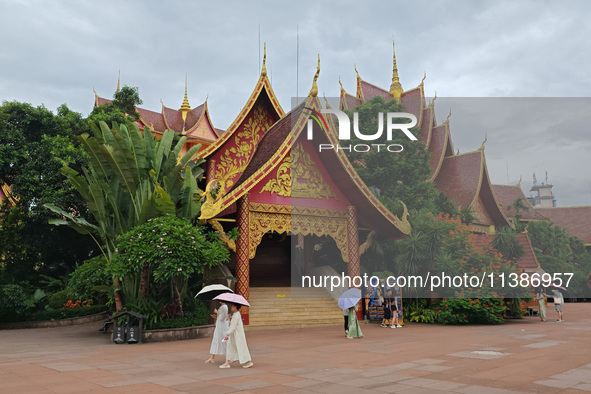 Tourists are enjoying the scenery in the Manting Imperial Garden in Xishuangbanna, China, on July 3, 2024. 