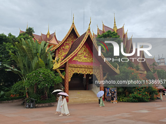 Tourists are enjoying the scenery in the Manting Imperial Garden in Xishuangbanna, China, on July 3, 2024. (