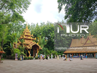 Tourists are enjoying the scenery in the Manting Imperial Garden in Xishuangbanna, China, on July 3, 2024. (