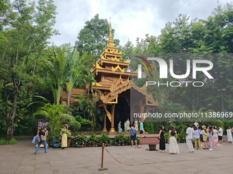 Tourists are enjoying the scenery in the Manting Imperial Garden in Xishuangbanna, China, on July 3, 2024. (