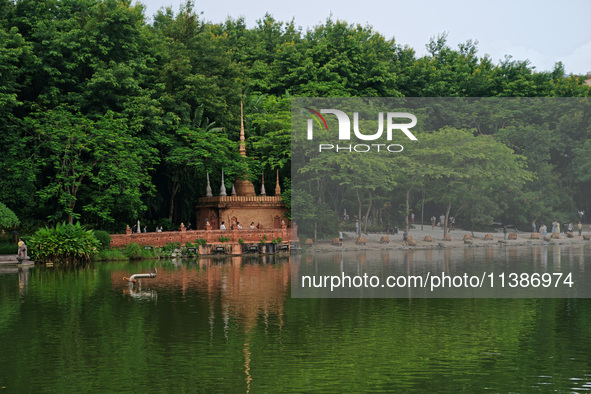 Tourists are enjoying the scenery in the Manting Imperial Garden in Xishuangbanna, China, on July 3, 2024. 