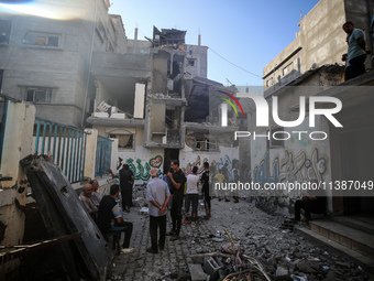 Palestinians are checking the destruction after an Israeli strike the previous day on a house in the Nuseirat refugee camp in the central Ga...