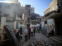 Palestinians are checking the destruction after an Israeli strike the previous day on a house in the Nuseirat refugee camp in the central Ga...