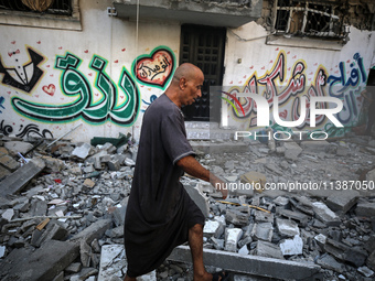 Palestinians are checking the destruction after an Israeli strike the previous day on a house in the Nuseirat refugee camp in the central Ga...