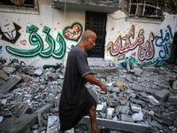 Palestinians are checking the destruction after an Israeli strike the previous day on a house in the Nuseirat refugee camp in the central Ga...