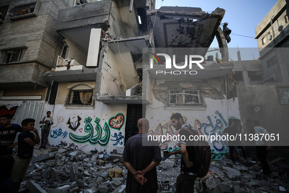 Palestinians are checking the destruction after an Israeli strike the previous day on a house in the Nuseirat refugee camp in the central Ga...