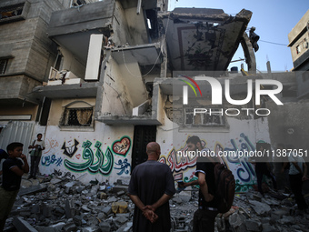 Palestinians are checking the destruction after an Israeli strike the previous day on a house in the Nuseirat refugee camp in the central Ga...