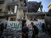 Palestinians are checking the destruction after an Israeli strike the previous day on a house in the Nuseirat refugee camp in the central Ga...