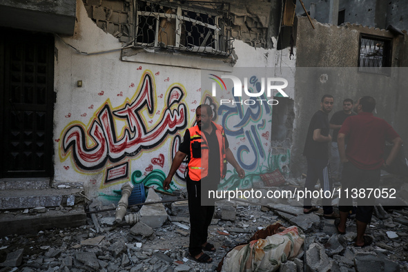 Palestinians are checking the destruction after an Israeli strike the previous day on a house in the Nuseirat refugee camp in the central Ga...