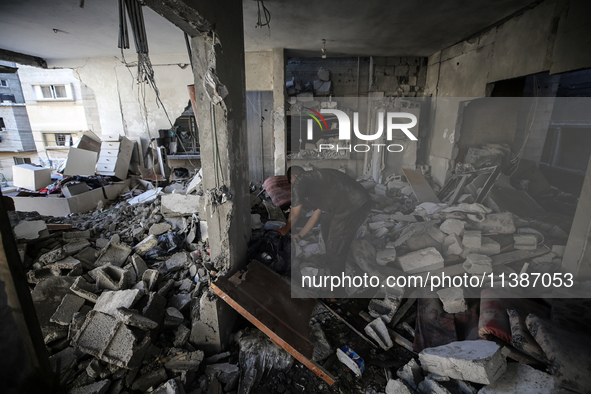 Palestinians are checking the destruction after an Israeli strike the previous day on a house in the Nuseirat refugee camp in the central Ga...