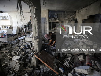 Palestinians are checking the destruction after an Israeli strike the previous day on a house in the Nuseirat refugee camp in the central Ga...