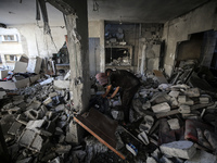 Palestinians are checking the destruction after an Israeli strike the previous day on a house in the Nuseirat refugee camp in the central Ga...