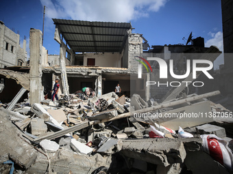 Palestinians are checking the destruction after an Israeli strike the previous day on a house in the Nuseirat refugee camp in the central Ga...