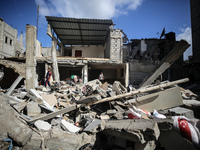 Palestinians are checking the destruction after an Israeli strike the previous day on a house in the Nuseirat refugee camp in the central Ga...