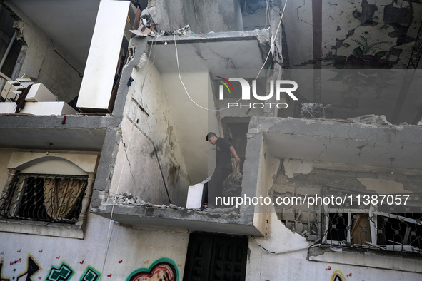 Palestinians are checking the destruction after an Israeli strike the previous day on a house in the Nuseirat refugee camp in the central Ga...