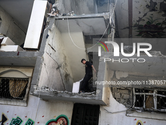 Palestinians are checking the destruction after an Israeli strike the previous day on a house in the Nuseirat refugee camp in the central Ga...