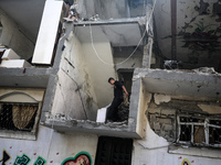 Palestinians are checking the destruction after an Israeli strike the previous day on a house in the Nuseirat refugee camp in the central Ga...