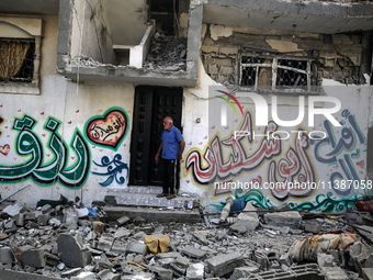 Palestinians are checking the destruction after an Israeli strike the previous day on a house in the Nuseirat refugee camp in the central Ga...