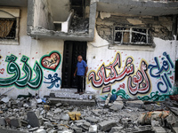 Palestinians are checking the destruction after an Israeli strike the previous day on a house in the Nuseirat refugee camp in the central Ga...