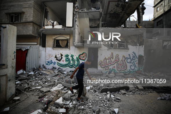 Palestinians are checking the destruction after an Israeli strike the previous day on a house in the Nuseirat refugee camp in the central Ga...