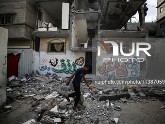 Palestinians are checking the destruction after an Israeli strike the previous day on a house in the Nuseirat refugee camp in the central Ga...