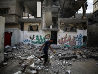 Palestinians are checking the destruction after an Israeli strike the previous day on a house in the Nuseirat refugee camp in the central Ga...