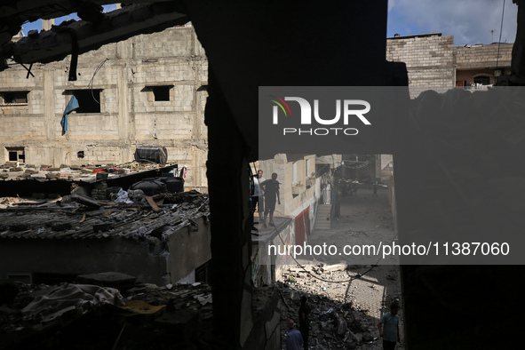 Palestinians are checking the destruction after an Israeli strike the previous day on a house in the Nuseirat refugee camp in the central Ga...