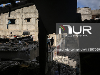 Palestinians are checking the destruction after an Israeli strike the previous day on a house in the Nuseirat refugee camp in the central Ga...