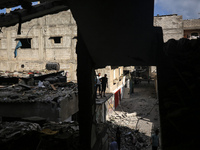 Palestinians are checking the destruction after an Israeli strike the previous day on a house in the Nuseirat refugee camp in the central Ga...