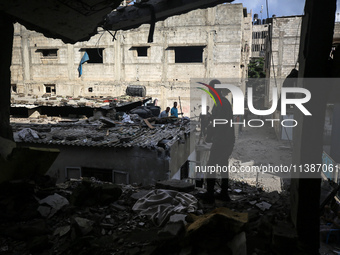 Palestinians are checking the destruction after an Israeli strike the previous day on a house in the Nuseirat refugee camp in the central Ga...