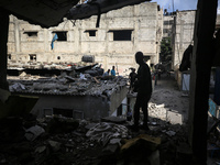 Palestinians are checking the destruction after an Israeli strike the previous day on a house in the Nuseirat refugee camp in the central Ga...