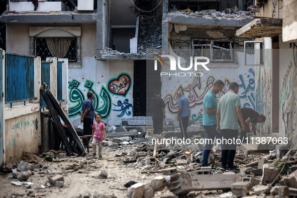 Palestinians are checking the destruction after an Israeli strike the previous day on a house in the Nuseirat refugee camp in the central Ga...