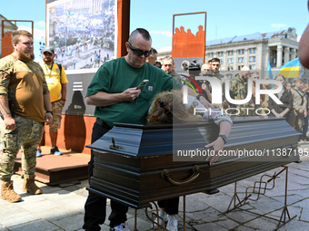 People are taking part in a funeral ceremony for British volunteer and combat medic Peter Fouche at Independence Square in Kyiv, Ukraine, on...