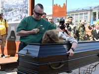 People are taking part in a funeral ceremony for British volunteer and combat medic Peter Fouche at Independence Square in Kyiv, Ukraine, on...