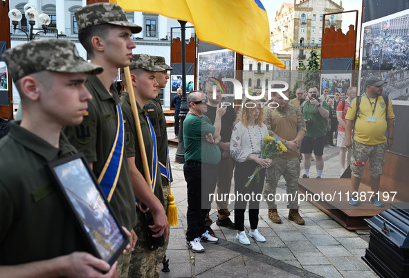 People are taking part in a funeral ceremony for British volunteer and combat medic Peter Fouche at Independence Square in Kyiv, Ukraine, on...