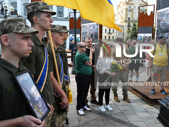 People are taking part in a funeral ceremony for British volunteer and combat medic Peter Fouche at Independence Square in Kyiv, Ukraine, on...