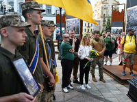 People are taking part in a funeral ceremony for British volunteer and combat medic Peter Fouche at Independence Square in Kyiv, Ukraine, on...