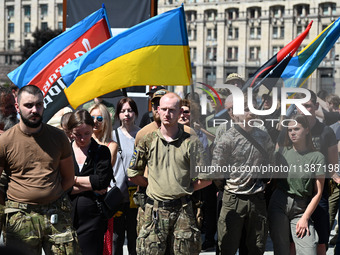 People are taking part in a funeral ceremony for British volunteer and combat medic Peter Fouche at Independence Square in Kyiv, Ukraine, on...