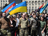 People are taking part in a funeral ceremony for British volunteer and combat medic Peter Fouche at Independence Square in Kyiv, Ukraine, on...