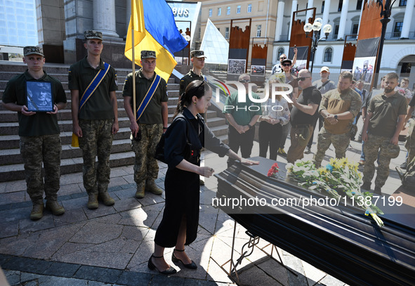 People are taking part in a funeral ceremony for British volunteer and combat medic Peter Fouche at Independence Square in Kyiv, Ukraine, on...