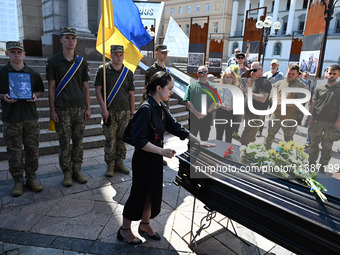 People are taking part in a funeral ceremony for British volunteer and combat medic Peter Fouche at Independence Square in Kyiv, Ukraine, on...