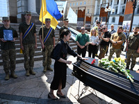 People are taking part in a funeral ceremony for British volunteer and combat medic Peter Fouche at Independence Square in Kyiv, Ukraine, on...