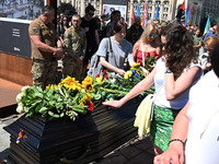 People are taking part in a funeral ceremony for British volunteer and combat medic Peter Fouche at Independence Square in Kyiv, Ukraine, on...