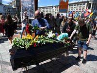 People are taking part in a funeral ceremony for British volunteer and combat medic Peter Fouche at Independence Square in Kyiv, Ukraine, on...