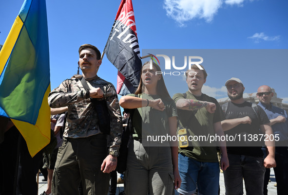 People are shouting slogans during a funeral ceremony for British volunteer and combat medic Peter Fouche at Independence Square in Kyiv, Uk...