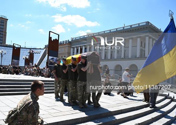 Members of the Honour Guard are carrying a coffin with the body of British volunteer and combat medic Peter Fouche during his funeral ceremo...