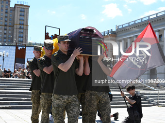 Members of the Honour Guard are carrying a coffin with the body of British volunteer and combat medic Peter Fouche during his funeral ceremo...