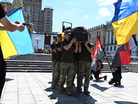 Members of the Honour Guard are carrying a coffin with the body of British volunteer and combat medic Peter Fouche during his funeral ceremo...