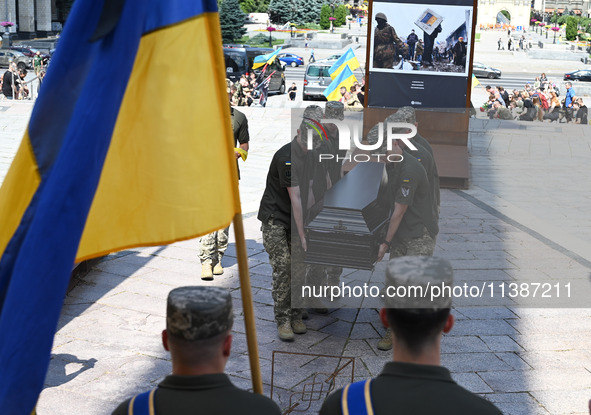 Members of the Honour Guard are carrying a coffin with the body of British volunteer and combat medic Peter Fouche during his funeral ceremo...